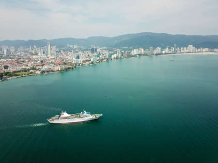 Georgetown, Penang/Malaysia - Mar 17 2020: Cruise ship sail at Penang sea. Back is Penang Island.のeditorial素材