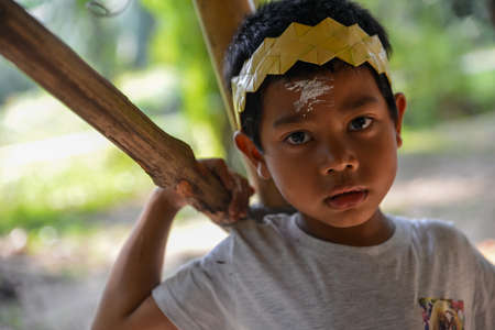 Carey Island, Selangor/Malaysia - Mar 17 2018: Mah Meri kid look at camera.のeditorial素材