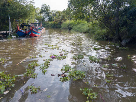 Bukit Tambun, Penang/Malaysia - May 07 2019: Rubbish flow in river near fishing vilalge.のeditorial素材