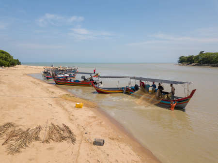 Kuala Muda, Penang/Malaysia - May 24 2019: Fishermen clean the net near the beach.のeditorial素材