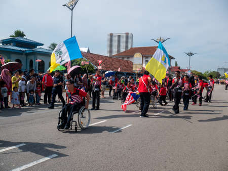 Butterworth, Kuala Lumpur/Malaysia - Aug 31 2019: Men in wheel chair join Malaysia independence...
