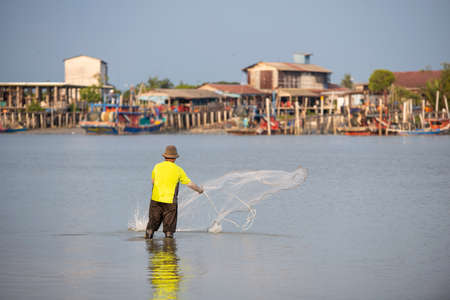Sekinchan, Selangor/Malaysia - Oct 06 2019: A fisherman throw the net. Background is fishing...