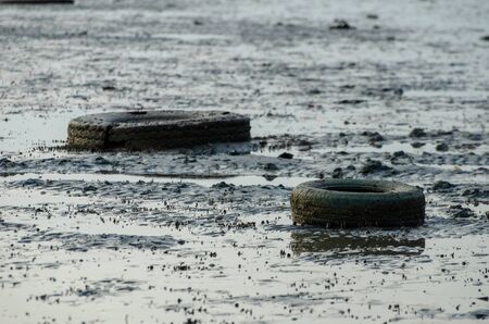 Old car tire at sea coastal.の写真素材
