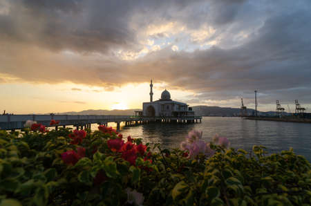 Butterworth, Penang/Malaysia - Jan 05 2020: Floating Mosque with foreground of beautiful flower.