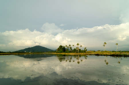 Rural Malays village reflection in water.