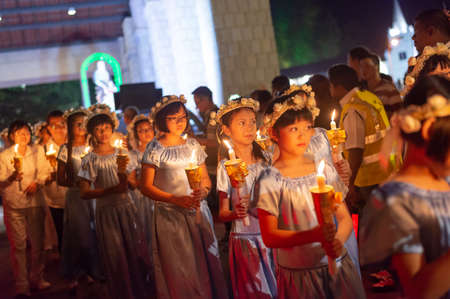 Bukit Mertajam, Penang/Malaysia - Jul 26 2015: Child carry candle during procession St Anne.のeditorial素材
