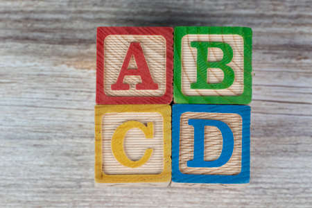 ABCD wooden block alphabet puzzle on wood backgroundの写真素材