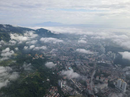Aerial view low cloud at Paya Terubong town in misty day morningの写真素材