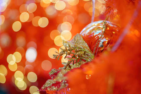 Christmas fake poinsettia flower flower decoration with blur bokeh background. New year ornament display conceptの写真素材