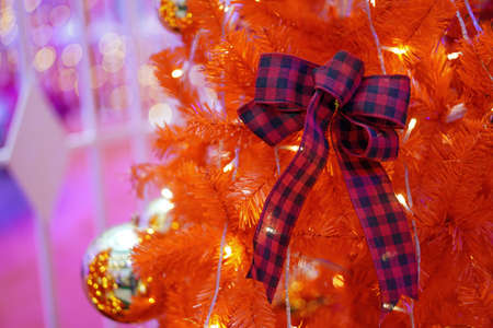 Ribbon on red fake christmas tree. New year ornament display conceptの写真素材