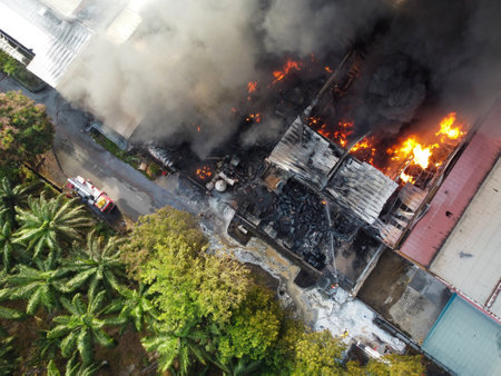 Aerial top down view fire happen at building release smokeの写真素材