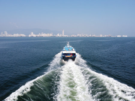 Butterworth, Penang, Malaysia - Mar 12 2022: Passenger ferry move at sea with wave at backのeditorial素材