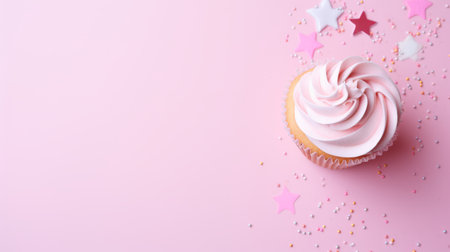 A cupcake and confetti pink background for a festive vibeの素材
