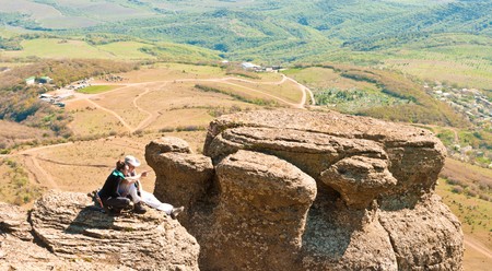 a couple sitting on therockの写真素材