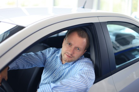 Handsome man in his new car 