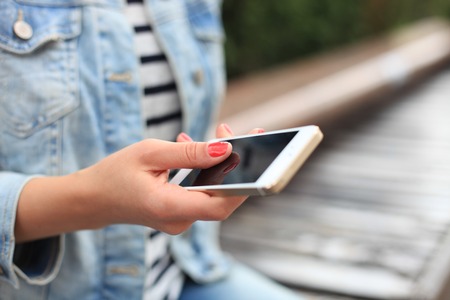 Close up of a woman using mobile smart phoneの写真素材