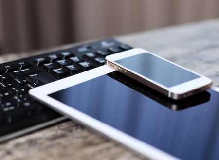 Modern workplace with digital tablet computer and mobile phone