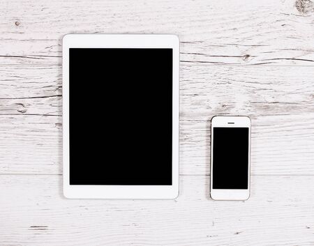 Mobile phone, tablet computer on wooden backgroundの写真素材