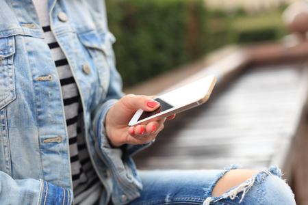 Close up of a woman using mobile smart phoneの写真素材