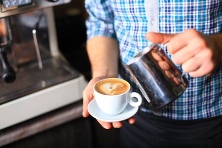 how to make latte art by barista focus in milk and coffeeの写真素材