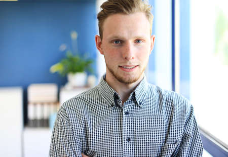 happy young business man work in modern officeの写真素材