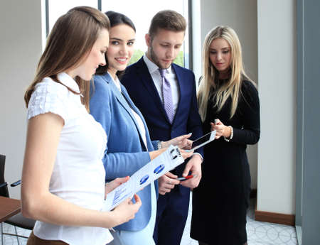 Image of four successful businesswomen looking at camera at meetingの写真素材