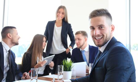 Businessman with colleagues in the background in office