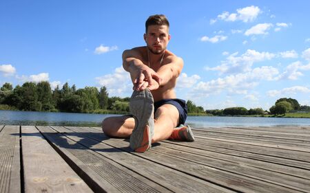 Athletic Man Stretching Before Workoutの写真素材