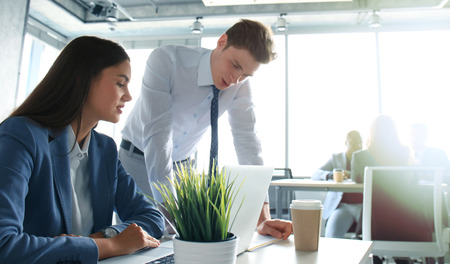 Image of two young business partners discussing plans or ideas at meetingの写真素材