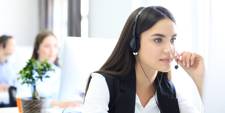 Attractive positive young businesspeople and colleagues in a call center office