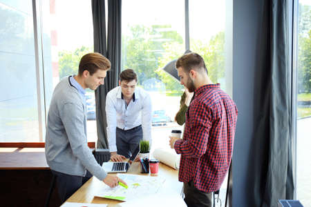 startup business team on meeting in modern bright office interior brainstorming, working on laptop and tablet computer.の写真素材