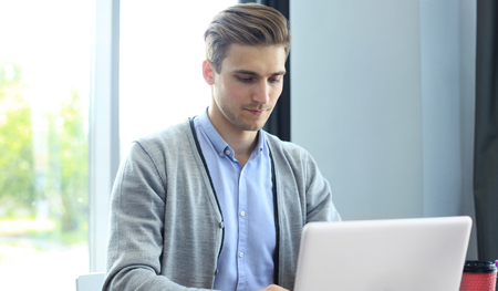 Young businessman working with laptop at office.の写真素材