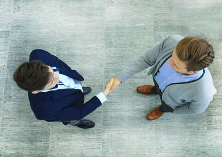 Top view of a two businessman shaking hands. Welcome to business.の写真素材
