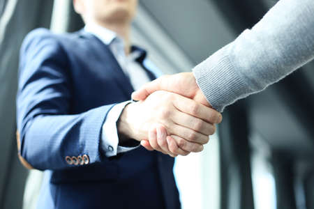 Business people shaking hands, finishing up a meeting.
