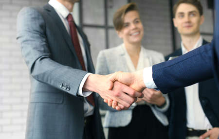 Business people shaking hands, finishing up a meeting.