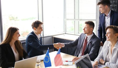 European Union and American leaders shaking hands on a deal agreement.の写真素材