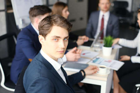 Businessman with colleagues in the background in office.の写真素材