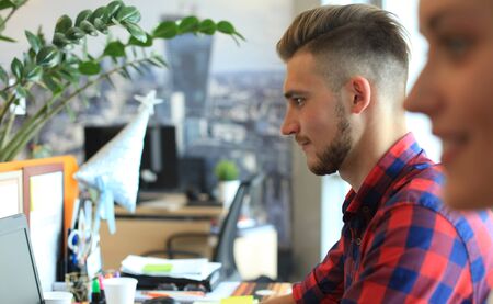 Startup business, two handsame businessmen working on computer at modern office.の写真素材