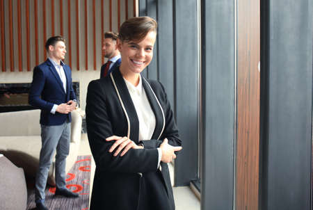 Face of beautiful woman on the background of business people.の写真素材