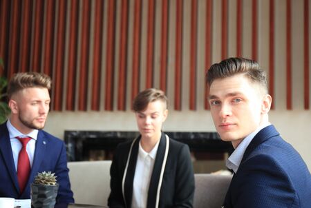 Happy smart business man with team mates discussing.の写真素材