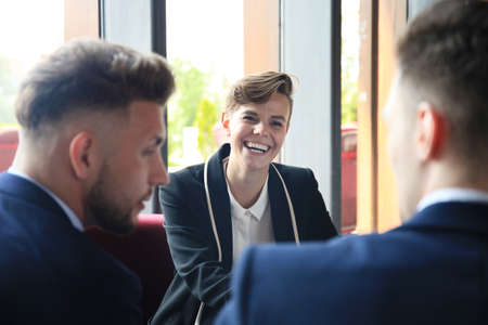 Face of beautiful woman on the background of business people.の写真素材