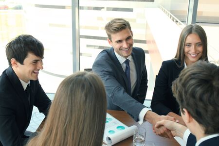 Business people shaking hands, finishing up a meeting.