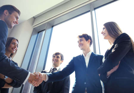 Business people shaking hands, finishing up a meeting.