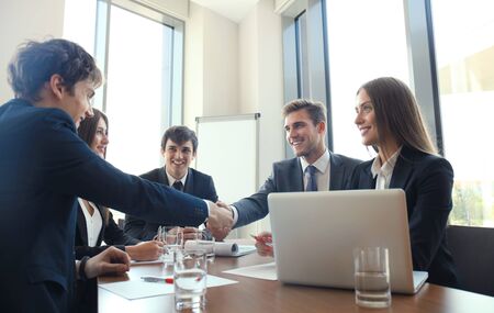 Business people shaking hands, finishing up a meeting.の写真素材