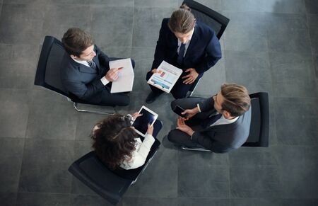 Creative business people meeting in circle of chairsの写真素材