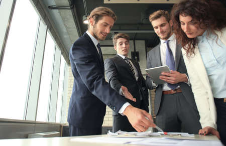 Business team discussing together business plans in officeの写真素材