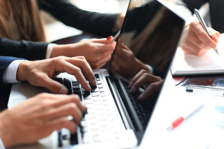 Business partners working together at office desk, they are using a laptopの写真素材