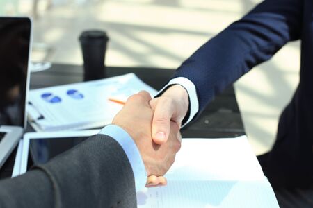 Business people shaking hands, finishing up a meeting.の写真素材