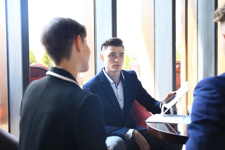 Happy smart business man with team mates discussing.