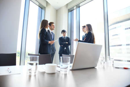 Team young professionals having casual discussion in office. Executives having friendly discussion during break.の写真素材
